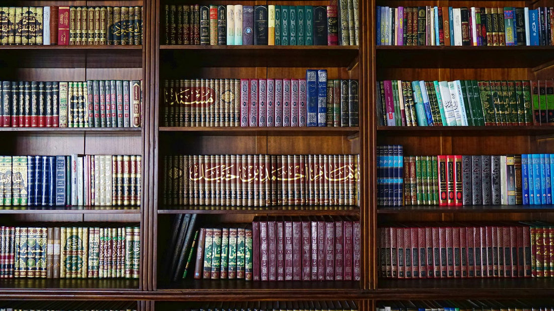 Shelves of classical Arabic Islamic books in gold-tooled bindings, including major hadith and fiqh collections