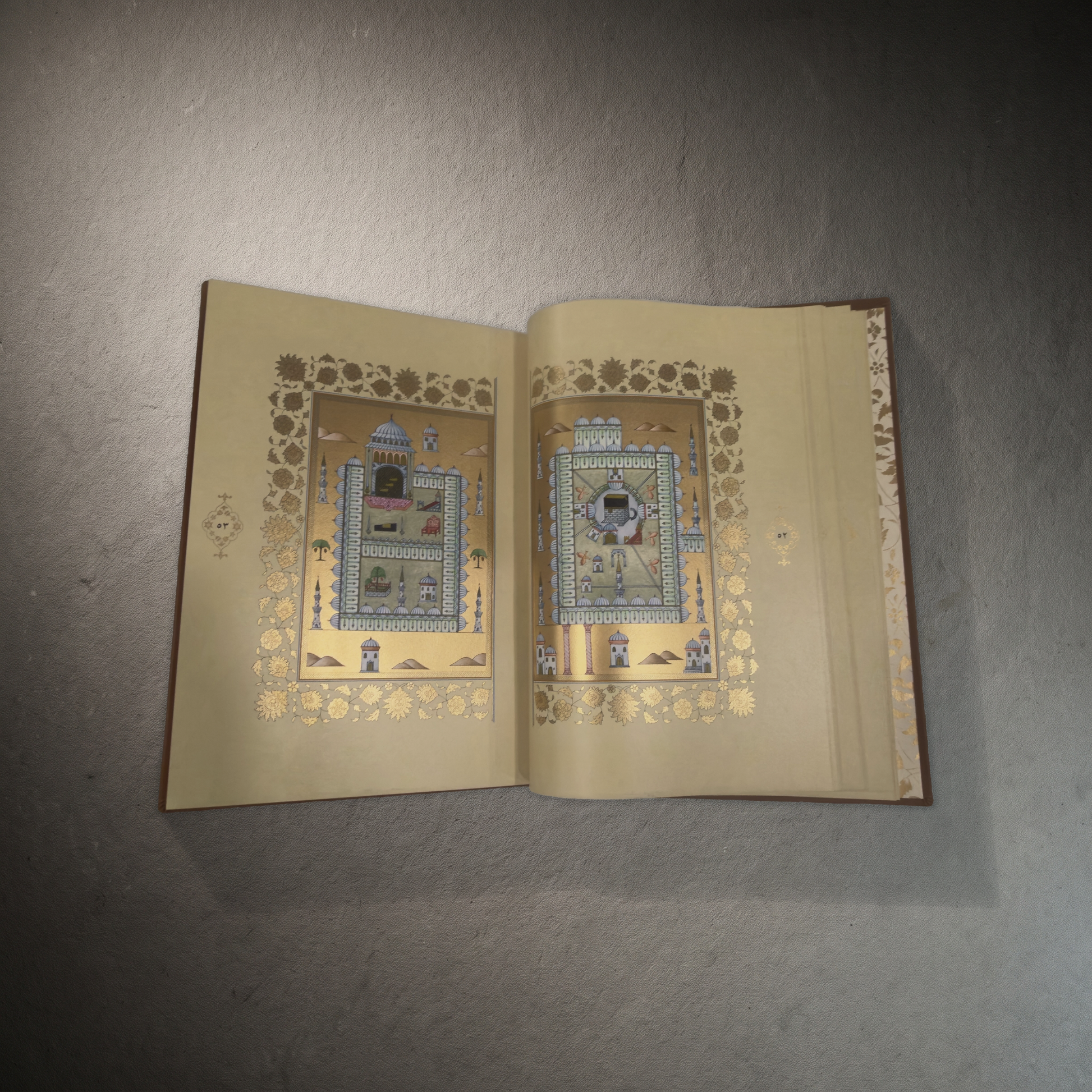 Dala'il al-Khayrat artistic edition — the Kaaba at Mecca and the Mosque of the Prophet at Medina on facing leaves of gold